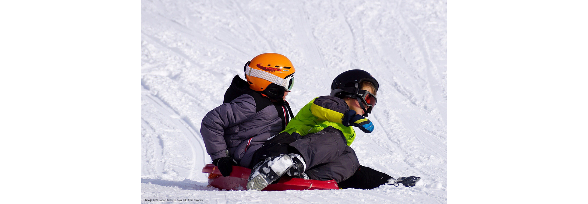 Two children tobogganing
