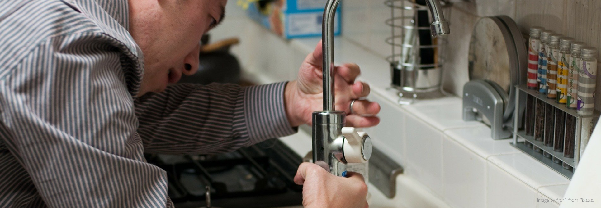 Man installing new kitchen faucet