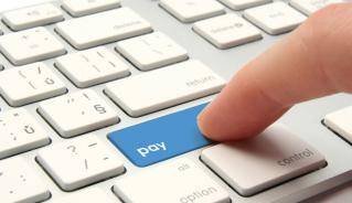 Picture of finger on computer keyboard press pay button