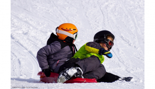 Two children tobogganing