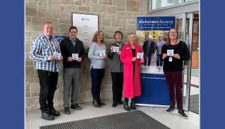 Justin Fidler, Lise Massen, Sean Hanlon and Mayor Aina DeViet of Middlesex Centre, and Leslie Rand and Susan Oster from the Alzheimer Society Southwest Partners, hold the new Dementia Friendly Community Supporter decals that will be going up at municipal buildings.