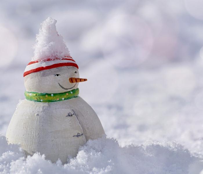 snowman sitting in snow