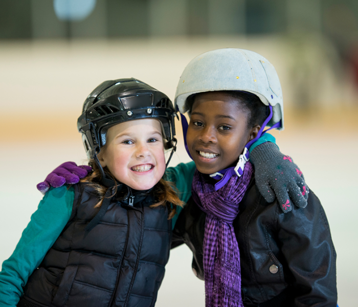 Two girls ice skating